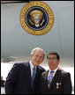 President George W. Bush embraces U.S. Freedom Corps volunteer Joey Rizzolo, Jr., of Paramus, N.J., on the President's arrival Monday, Sept. 22, 2008, to John F. Kennedy International Airport in New York. Rizzolo has been recognized as one of the top youth volunteers in America. White House photo by Eric Draper
