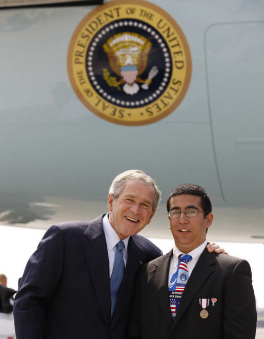 President George W. Bush embraces U.S. Freedom Corps volunteer Joey Rizzolo, Jr., of Paramus, N.J., on the President's arrival Monday, Sept. 22, 2008, to John F. Kennedy International Airport in New York. Rizzolo has been recognized as one of the top youth volunteers in America. White House photo by Eric Draper