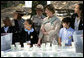 Mrs. Laura Bush and children from the Adam Clayton Powell Jr. Elementary School (P.S. 153) and the Boys and Girls Club of Harlem do 'cup planting' as part of the First Bloom program at the Hamilton Grange National Memorial in New York City, Sept. 24, 2008. The children will take care of the seedlings in the cups throughout the winter and plant them in the park in the spring. White House photo by Chris Greenberg