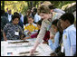 Mrs. Laura Bush and children from the Adam Clayton Powell Jr. Elementary School (P.S. 153) and the Boys and Girls Club of Harlem do a 'soil sampling' as part of the First Bloom program at the Hamilton Grange National Memorial in New York City, Sept. 24, 2008. The activity helps children learn about the characteristics of local soil and thus the kinds of plants best suited to the area. The park is the historic home of Alexander Hamilton. White House photo by Chris Greenberg