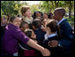 Mrs. Laura Bush receives a big group hug from children visiting from the Adam Clayton Powell Jr. Elementary School (P.S. 153) and the Boys and Girls Club of Harlem at the conclusion of a First Bloom program at the Hamilton Grange National Memorial in New York City, Sept. 24, 2008. The First Bloom program is a national conservation education program for the National Park Foundation that encourages young people to protect the environment in America's National Parks and in their own back yards. White House photo by Chris Greenberg