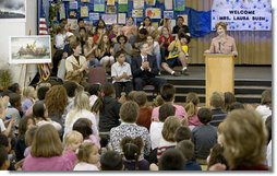 Mrs. Laura Bush addresses the Riverside Elementary School assembly in Bismarck, N.D., Thursday, Oct. 2, 2008, about the National Endowment for the Humanities' Picturing America' program. The program uses iconic artwork - such as the Washington Crossing the Delaware painting displayed nearby - and photography to teach children about architecture, art, and history as they discuss the images. White House photo by Chris Greenberg