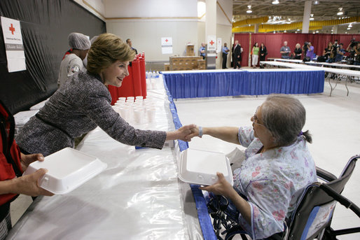 Mrs. Laura Bush hands a meal to Hurricane Ike evacuee Barbara Woodarek Friday, Oct. 3, 2008, during her visit to the Auchan Red Cross Shelter in Houston for those individiuals and families still in need of assistance as a result of Hurricane Ike. White House photo by Chris Greenberg