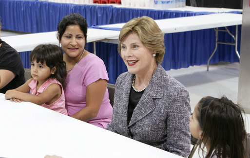 Mrs. Laura Bush visits with evacuee Deseray Ortiz and her daughters, Delilah, 3, left and Mariah, 8, right, Friday, Oct. 3, 2008, at the Auchan Red Cross Shelter in Houston for those individiuals and families who still need assistance as a result of Hurricane Ike. White House photo by Chris Greenberg