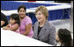 Mrs. Laura Bush visits with evacuee Deseray Ortiz and her daughters, Delilah, 3, left and Mariah, 8, right, Friday, Oct. 3, 2008, at the Auchan Red Cross Shelter in Houston for those individiuals and families who still need assistance as a result of Hurricane Ike. White House photo by Chris Greenberg