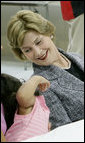 Mrs. Laura Bush shares a moment with Delilah Winters, 3, during a visit Friday, Oct. 3, 2008, to the Auchan Red Cross Shelter in Houston for those individiuals and families who still need assistance as a result of Hurricane Ike. White House photo by Chris Greenberg