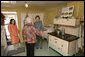 Mrs. Laura Bush receives an explanation of the scale of author Laura Ingalls Wilder's kitchen from Mrs. Jean Coday, Director and President of the Laura Ingalls Wilder Historic Home and Museum in Mansfield, Mo., Oct. 3, 2008. Accompanying the two on the tour is Mrs. Melanie Blunt, First Lady of Missouri. Wilder is one of Mrs. Bush's favorite writers and she was surprised to see the petite kitchen, built to function for the 4-foot-10-inch author. White House photo by Chris Greenberg