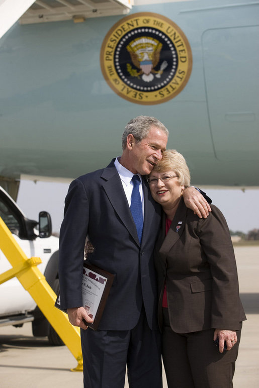 President George W. Bush embraces Freedom Corps greeter Nancy Arnold of Fairfield, Ohio, who President Bush honored with a Presidental Volunteer Service Award upon his arrival to Cincinnati/Northern Kentucky International Airport Monday, Oct. 6, 2008, in Hebron, Ky. White House photo by Eric Draper