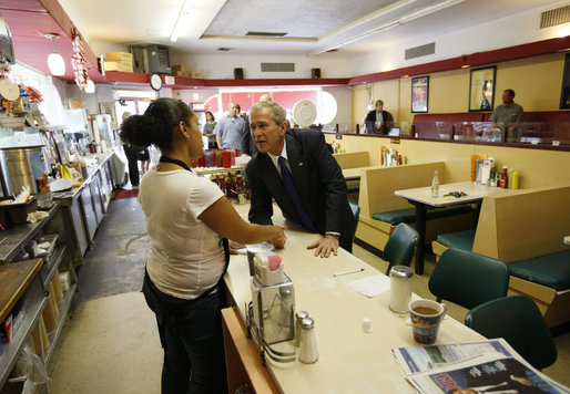President George W. Bush greets an employee inside Olmos Pharmacy in San Antonio, Texas Monday, Oct. 6, 2008, where he greeted local citizens and met with business owners about the current economic climate. The Pharmacy was established in 1938 and while it no longer operates as a pharmacy, it has retained its original soda fountain and lunch counter. White House photo by Eric Draper
