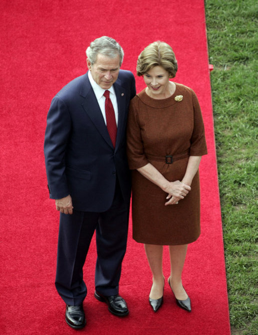 President George W. Bush and Mrs. Laura Bush stand together as they wait for the arrival of Prime Minister Silvio Berlusconi of Italy Monday, Oct. 13, 2008, during a South Lawn ceremony for the Prime Minister at the White House. White House photo by Grant Miller