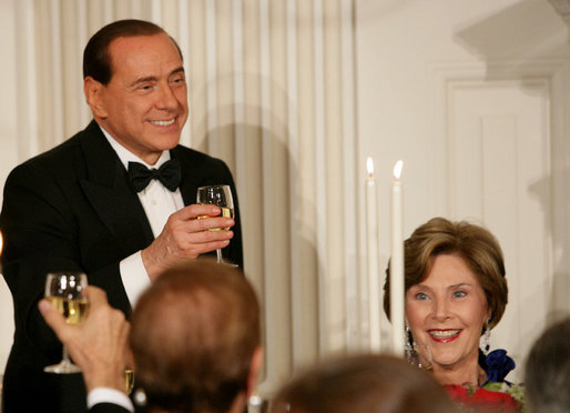 Prime Minister Silvio Berlusconi of Italy, seated next to Mrs. Laura Bush, acknowledges a toast offered in his honor by President George W. Bush Monday evening, Oct. 13, 2008, at the White House State Dinner in honor of Berlusconi's visit to Washington, D.C. White House photo by Chris Greenberg