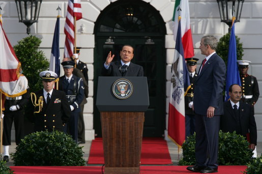 President George W. Bush listens as Prime Minister Silvio Berlusconi addresses his remarks Monday, Oct. 13, 2008, during ceremonies on the South Lawn to welcome Prime Minister Berlusconi to the White House. White House photo by Chris Greenberg