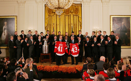 President George W. Bush stands with Detroit Red Wings captain Nicklas Lidstrom as they hold up jerseys Tuesday, Oct. 14, 2008 in the East Room at the White House, representing President Bush's father 41 and the President 43, during the ceremony to honor the Red Wings 2008 Stanley Cup championship. White House photo by Joyce N. Boghosian