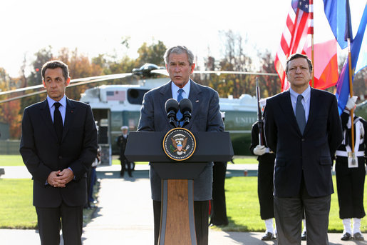 President George W. Bush is joined by French President Nicolas Sarkozy, left, and Jose Manuel Barroso, President of the European Commission as he addresses the media during a meeting at Camp David concerning the economic crisis and the need for coordinated global response Saturday, October 18, 2008. White House photo by Chris Greenberg