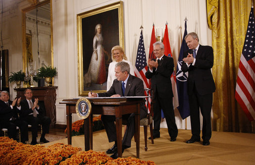 President George W. Bush is joined on stage by Croatian Ambassador to the U.S. Kolinda Grabar-Kitarovic, left, Albanian Ambassador to the U.S. Aleksander Saliabanda and NATO Secretary General Jaap De Hoop Scheffer, right, as he signs the NATO accession protocols Friday, Oct. 24, 2008 in the East Room of the White House, in support of the nations of Albania and Croatia to join the NATO alliance. When all 26 NATO allies have ratified the accession protocols Albania and Croatia will be eligible to join NATO. White House photo by Eric Draper