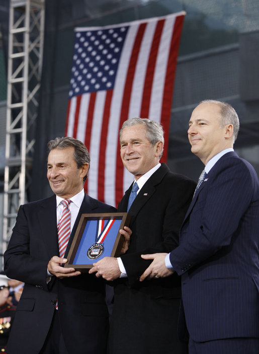 President George W. Bush is presented with the 2008 Intrepid Freedom Award by Rich Santulli, left, and Charles de Gunzberg, co-chairmen of the Intrepid Sea, Air and Space Museum, Tuesday, Nov. 11, 2008, during the rededication of the museum on Veteran's Day in New York. The award recognizes world leaders who embody the ideals of world freedom and democracy. White House photo by Eric Draper
