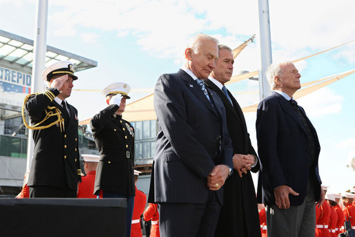 President George W. Bush, joined by former astronauts Edwin 'Buzz' Aldrin, left, and Scott Carpenter, stand together during a moment of silence after tossing a memorial wreath Tuesday, Nov. 11, 2008 from the deck of the USS Intrepid into the Hudson River, during a Veteran's Day tribute in New York. White House photo by Chris Greenberg