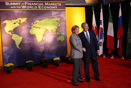 President George W. Bush welcomes Chancellor Angela Merkel of Germany to the Summit on Financial Markets and the World Economy Saturday, Nov. 15, 2008, at the National Building Museum in Washington, D.C. White House photo by Chris Greenberg