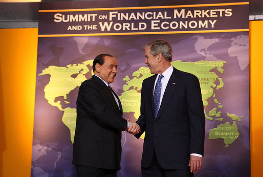 President George W. Bush welcomes Italy's Prime Minister Silvio Berlusconi to the Summit on Financial Markets and the World Economy Saturday, Nov. 15, 2008, at the National Building Museum in Washington, D.C. White House photo by Chris Greenberg