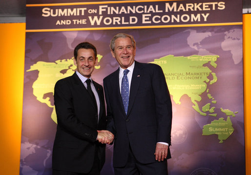President George W. Bush welcomes French President Nicolas Sarkozy to the Summit on Financial Markets and the World Economy Saturday, Nov. 15, 2008, at the National Building Museum in Washington, D.C. White House photo by Chris Greenberg