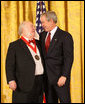 President George W. Bush congratulates Myron Magnet, editor of the City Journal of New York, as a recipient of the 2008 National Humanities Medal in ceremonies Monday, Nov. 17, 2008 at the White House. White House photo by Chris Greenberg