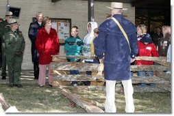 Mrs. Laura Bush watches with children as a reenactor demonstrates rail splitting during her visit to the Abraham Lincoln Birthplace National Historical Site Tuesday, Nov. 18, 2008, in Hodgenville, KY. White House photo by Joyce N. Boghosian
