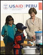 Mrs. Laura Bush and Ms. Nancy Quispitupa, Program Manager and Community Trainer, watch as 8-year-old William Sebastian Hernandez Jeri demonstrates learned hand-washing techniques Friday, Nov. 21, 2008, at the San Clemente Health Center in San Clemente, Peru. The center is the town's major health provider and serves an average of 80 patients per day. White House photo by Joyce N. Boghosian