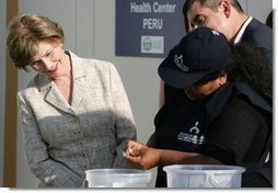 Mrs. Laura Bush looks on Friday, Nov. 21, 2008, as Ms. Maria Salguero Trillo, Community Health Educator Volunteer at the San Clemente Health Center in San Clemente, Peru, demonstrates how families are trained to treat contaminated water for safe drinking. In the town of 25,000, nearly 89 percent of the homes were affected by the August 2007, 8.0-magnitude earthquake. White House photo by Joyce N. Boghosian