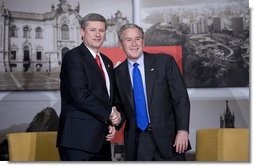 President George W. Bush and Prime Minister Stephen Harper of Canada smile for the cameras during a greeting Saturday, Nov. 22, 2008, prior to the their meeting in Lima, Peru. White House photo by Eric Draper