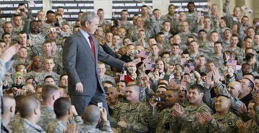 President George W. Bush acknowledges his audience as he enters the staging area Tuesday, Nov. 25, 2008, at Fort Campbell, Ky., home of the 101st Airborne. The President told the troops, "We are blessed to have defenders of such character and courage. I'm grateful to the families who serve by your side. And I will always be thankful for the honor of having served as the Commander-in-Chief." White House photo by Eric Draper