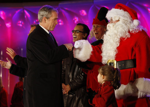 President George W. Bush exchanges knuckles with Santa Thursday, Dec. 4, 2008, during the 2008 Lighting of the National Christmas Tree Ceremony on the Ellipse in Washington, D.C. It is the 85th year of the ceremony that began during the Coolidge Administration. White House photo by Eric Draper