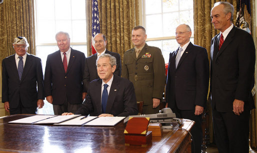 President George W. Bush smiles after signing the Presidential proclamation designating the World War II Valor in the Pacific National Monument and the Presidential proclamation in honor of National Pearl Harbor Remembrance Day 2008 in the Oval Office of the White House. With him for the signing Friday, Dec. 5, 2008, are from left: Pearl Harbor Survivor Jay Groff; George Sullivan, Chairman, Arizona Memorial Museum Association; Secretary Donald Winter, U.S. Department of the Navy; Gen. James "Hoss" Cartwright, Vice Chairman, Joint Chiefs of Staff; Secretary James Peake, U.S. Department of Veterans Affairs, and Secretary Dirk Kempthorne, U.S. Department of the Interior. White House photo by Eric Draper
