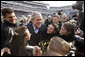 President George W. Bush is swarmed by the Army cheerleading squad Saturday, Dec. 8, 2008, on the field at Lincoln Financial Field in Philadelphia, for the 2008 Army-Navy game. White House photo by Eric Draper