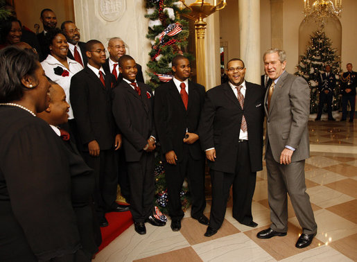 President George W. Bush welcomes members of the musical group Sweet Heaven Kings to the White House, Monday, Dec. 8, 2008, where the musical group performed at the Children's Holiday Reception and Performance. White House photo Eric Draper White House photo by Eric Draper