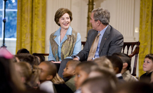 Mrs. Laura Bush and President George W. Bush sit with youngsters Monday, Dec. 8, 2008, during the Children's Holiday Reception and Performance in the East Room of the White House. White House photo by Eric Draper