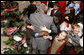 President George W. Bush is smothered in little hands as he says goodbye to a group of children in attendance Monday, Dec. 8, 2008, for the Children's Holiday Reception and Performance at the White House. The President and Mrs. Laura Bush traditionally invite children to a White House celebration for the holidays, and this year, the audience included kids of active duty and reserve military service members from Russell Elementary at Quantico Marine Base, Dahlgren School at Dahlgren Navy Base and West Meade Elementary at Ft. Meade Army Base. White House photo by Eric Draper