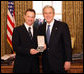 President George W. Bush stands with Gary Sinise after presenting him with the 2008 Presidential Citizens Medal Wednesday, Dec. 10, 2008, in the Oval Office of the White House. White House photo by Chris Greenberg