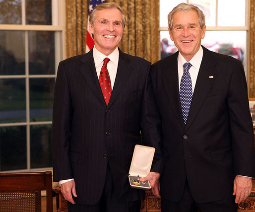 President George W. Bush stands with Raymond "Ray" Chambers after presenting him with the 2008 Presidential Citizens Medal Wednesday, Dec. 10, 2008, in the Oval Office of the White House. White House photo by Chris Greenberg