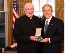 President George W. Bush stands with Father John P. Foley, S.J., after presenting him with the 2008 Presidential Citizens Medal Wednesday, Dec. 10, 2008, in the Oval Office of the White House. White House photo by Chris Greenberg