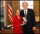 President George W. Bush stands with Kathy Downing after presenting her with the 2008 Presidential Citizens Medal Wednesday, Dec. 10, 2008, on behalf of her husband Gen. Wayne A. Downing, in the Oval Office of the White House. White House photo by Chris Greenberg