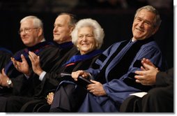President George W. Bush enjoys the moment with his mom, Mrs. Barbara Bush, and dad, former President George H.W. Bush, as they sit on stage at Reed Arena on the campus of Texas A&M University where the President addressed the 3,700 graduates of the school's Winter Class of 2008.  White House photo by Eric Draper