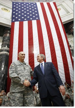 President George W. Bush stands on stage with U.S. Commander in Iraq, General Ray Odierno, Sunday, Dec. 14, 2008, following his address to U.S. military and diplomatic personnel at the Al Faw Palace-Camp Victory in Baghdad.  White House photo by Eric Draper