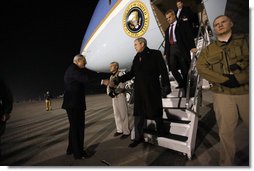 President George W. Bush is greeted as he deplanes Air Force One Monday, Dec. 15, 2008, after arriving in the pre-dawn hours in Afghanistan. The President visited with troops at Bagram Air Base, thanking them for their service and telling them, "I am proud to be with brave souls serving the United States of America."  White House photo by Eric Draper