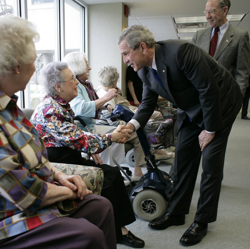 President George W. Bush and Senator Charles, Grassley, R-Iowa, greet residents at Wesley Acres Senior Center in Des Moines, Iowa, Tuesday, April 11, 2006. The President visited Iowa to talk about the Medicare prescription drug benefits. White House photo by Eric Draper