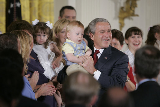 President George W. Bush holds 14-month-old Trey Jones of Cypress, Texas, following his remarks about stem cell research policy legislation in the East Room of the White House Wednesday, July 19, 2006. White House photo by Kimberlee Hewitt