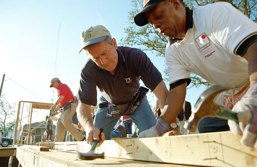 President George W. Bush helps raise a house during a visit June 5, 2001, to a Habitat for Humanity location in Tampa. White House photo by Eric Draper