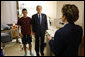President George W. Bush stands with U.S. Army Specialist Fernando Aguilar of Tucson, Ariz., Monday, Dec. 22, 2008 at Walter Reed Army Medical Center in Washington, D.C., as a White House military aide reads Aguilar's Purple Heart citation. Aguilar is recovering from injuries sustained when two hand grenades were thrown at his vehicle while on patrol in support of Operation Iraqi Freedom. White House photo by Eric Draper