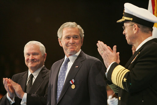 President George W. Bush glances at Admiral Mike Mullen, Chairman of the Joint Chiefs of Staff, as they stand with U.S. Secretary of Defense Robert Gates during a military tribute Tuesday, Jan. 6, 2009, at Ft. Myer in Arlington, Va. White House photo by Joyce N. Boghosian