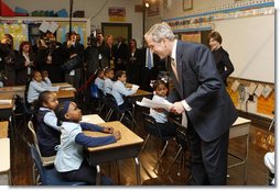 President George W. Bush talks with a young student during his visit with Mrs. Laura Bush to a second grade class Thursday, Jan. 8, 2008 at the General Philip Kearny School in Philadelphia. President Bush followed his class visit with an address on the No Child Left Behind Act, urging Congress to strenghten and reauthorize the legislation. White House photo by Chris Greenberg