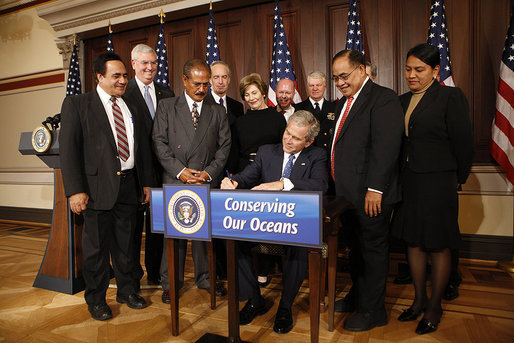 President George W. Bush signs one of three proclamations designating new Marine National Monuments in the Pacific during an event Tuesday, January 6, 2009, in the Eisenhower Executive Office Building. Joining in the signing ceremony were Mrs. Laura Bush, EPA Administrator Stephen Johnson, Interior Secretary Dirk Kempthorne, Commerce Secretary Carlos Gutierrez, Secretary Don Winter, Department of the Navy; Admiral Gary Roughead, Chief of Naval Operations; Bill Brennan, Administrator, National Oceanic and Atmospheric Administration, Department of Commerce; Governor Benigno Fitial, Northern Mariana Islands; Lelei Peau, Deputy Director, American Samoa Department of Commerce; Ray Tulafono, Director, American Samoa Department of Marine and Wildlife Resources; and Jim Connaughton, Chairman, Council of Environmental Quality. White House photo by Chris Greenberg